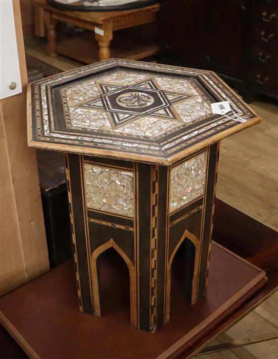 A Moorish ebony and mother of pearl inlaid hexagonal table W.47cm